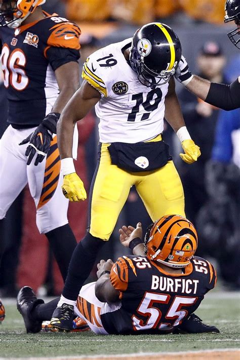 standing football player|football player standing over another.